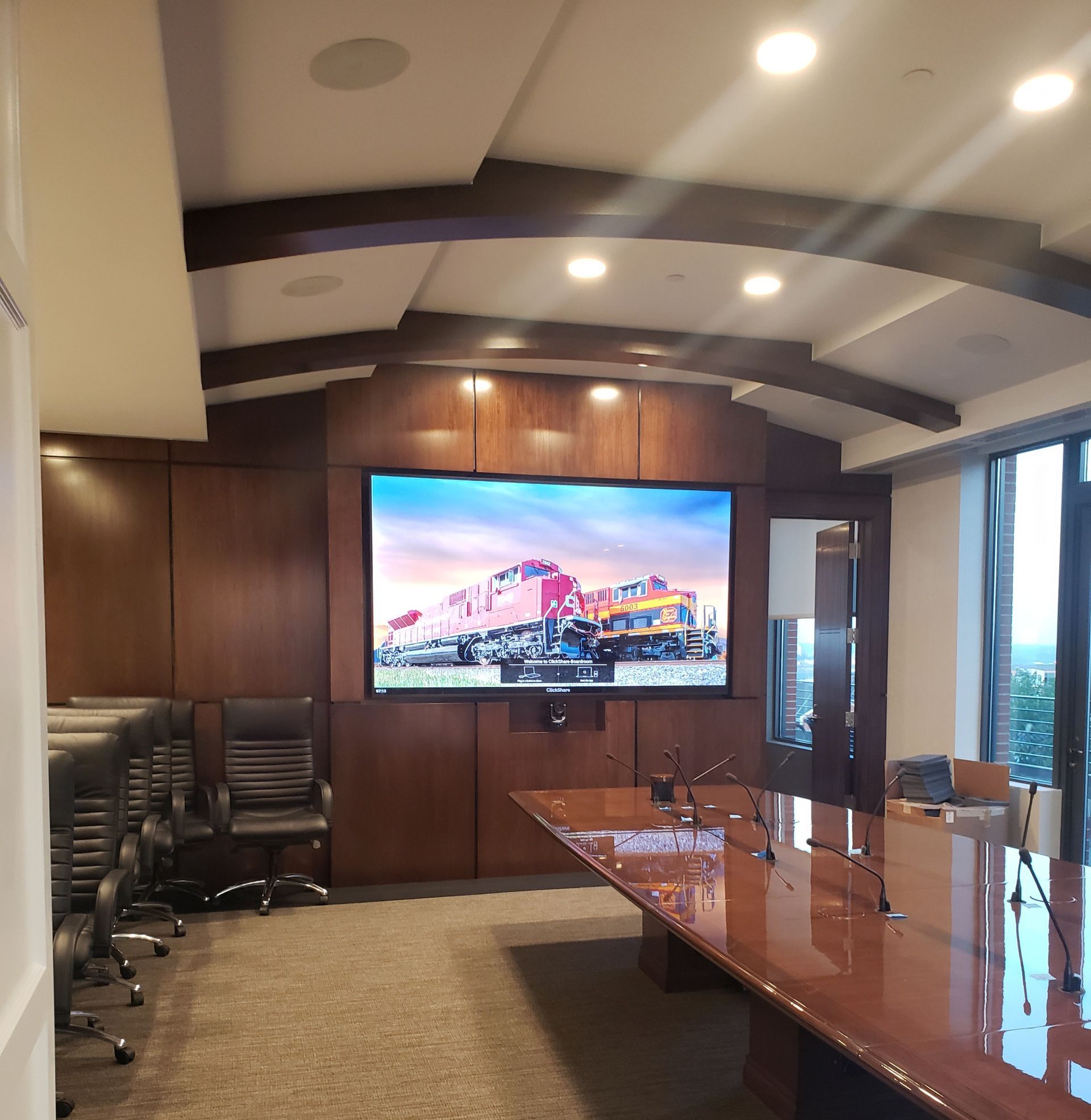 A conference room with a large screen on the wall