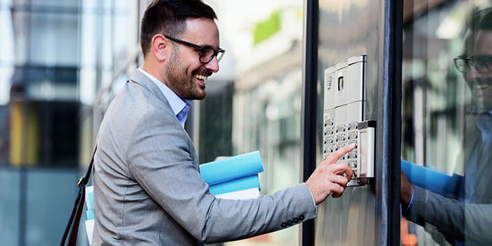 A man is using a keypad to open a door.