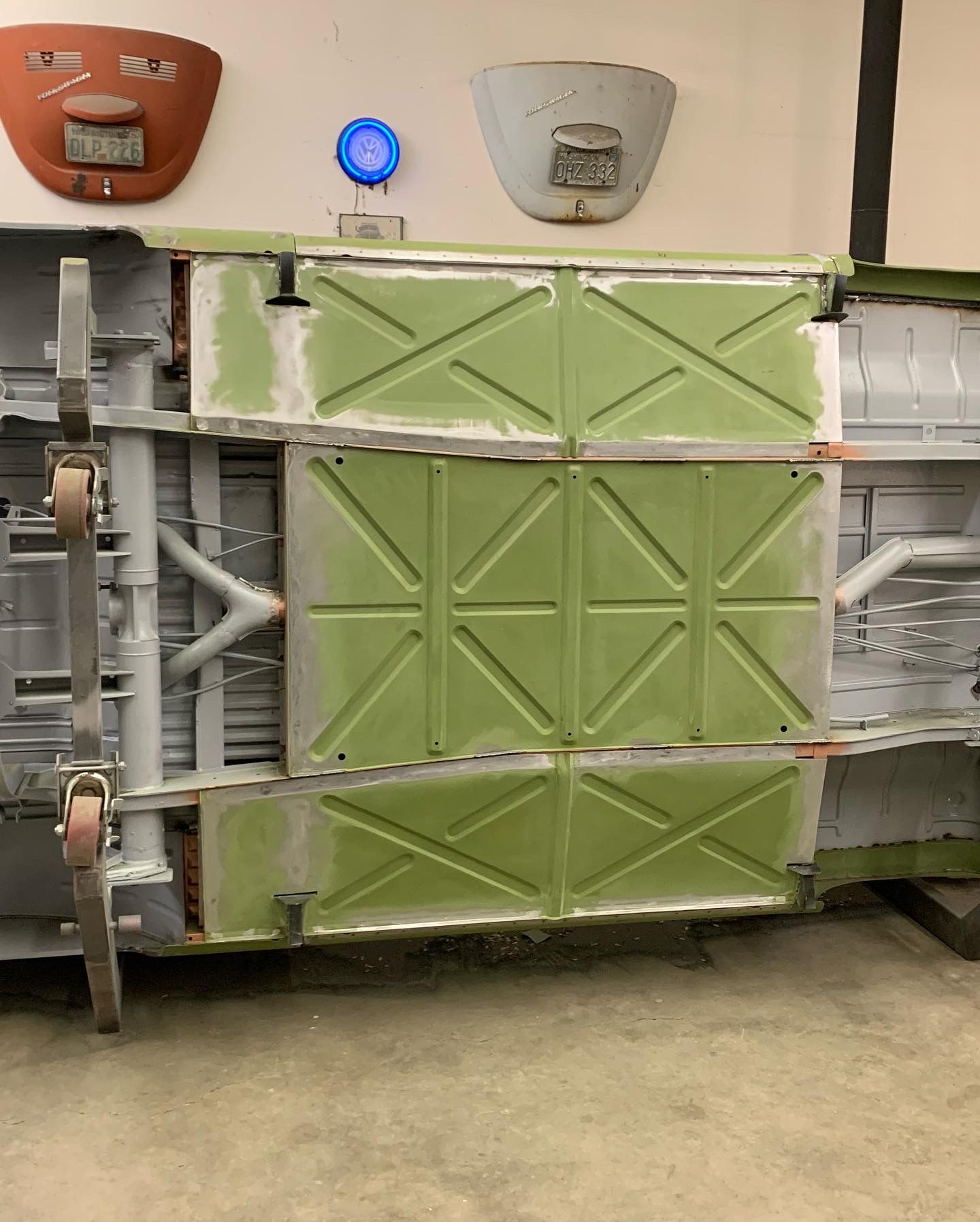 Green metal cargo door on a container or trailer in an industrial setting