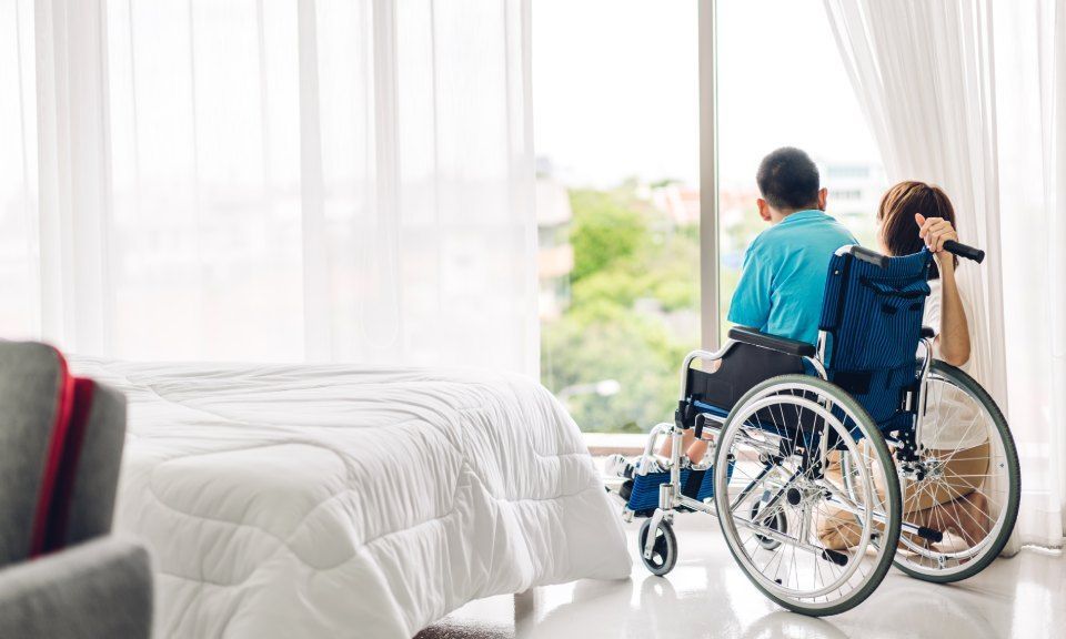Disabled child sitting in a wheelchair, enjoying good times at home. Taking care of a child with a disability.