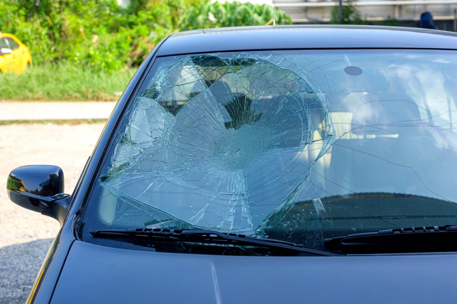 A Black Car with A Broken Windshield Is Parked on The Side of The Road | Perth, WA | Perth Windscreens and Autoglass