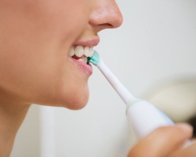 brushing teeth with electric toothbrush