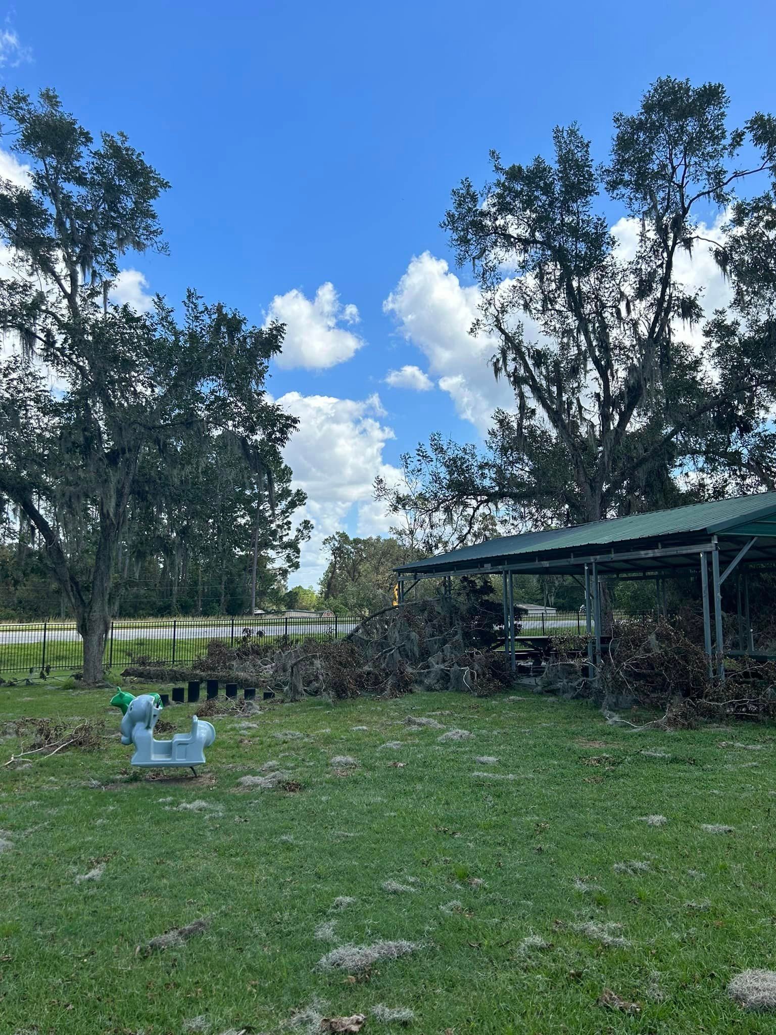A rocking horse is in the middle of a grassy field