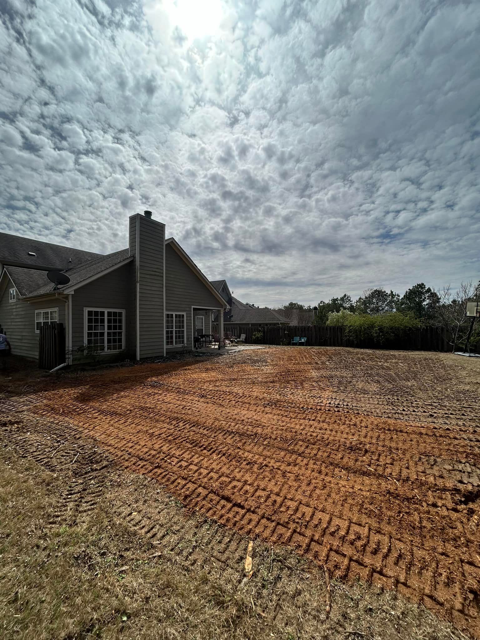 A house with a lot of dirt in front of it.