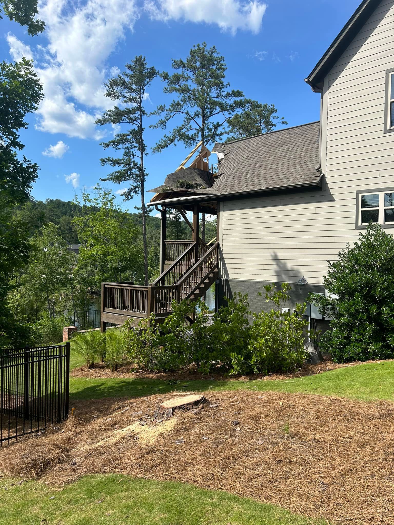 A house with a deck and stairs on the side of it