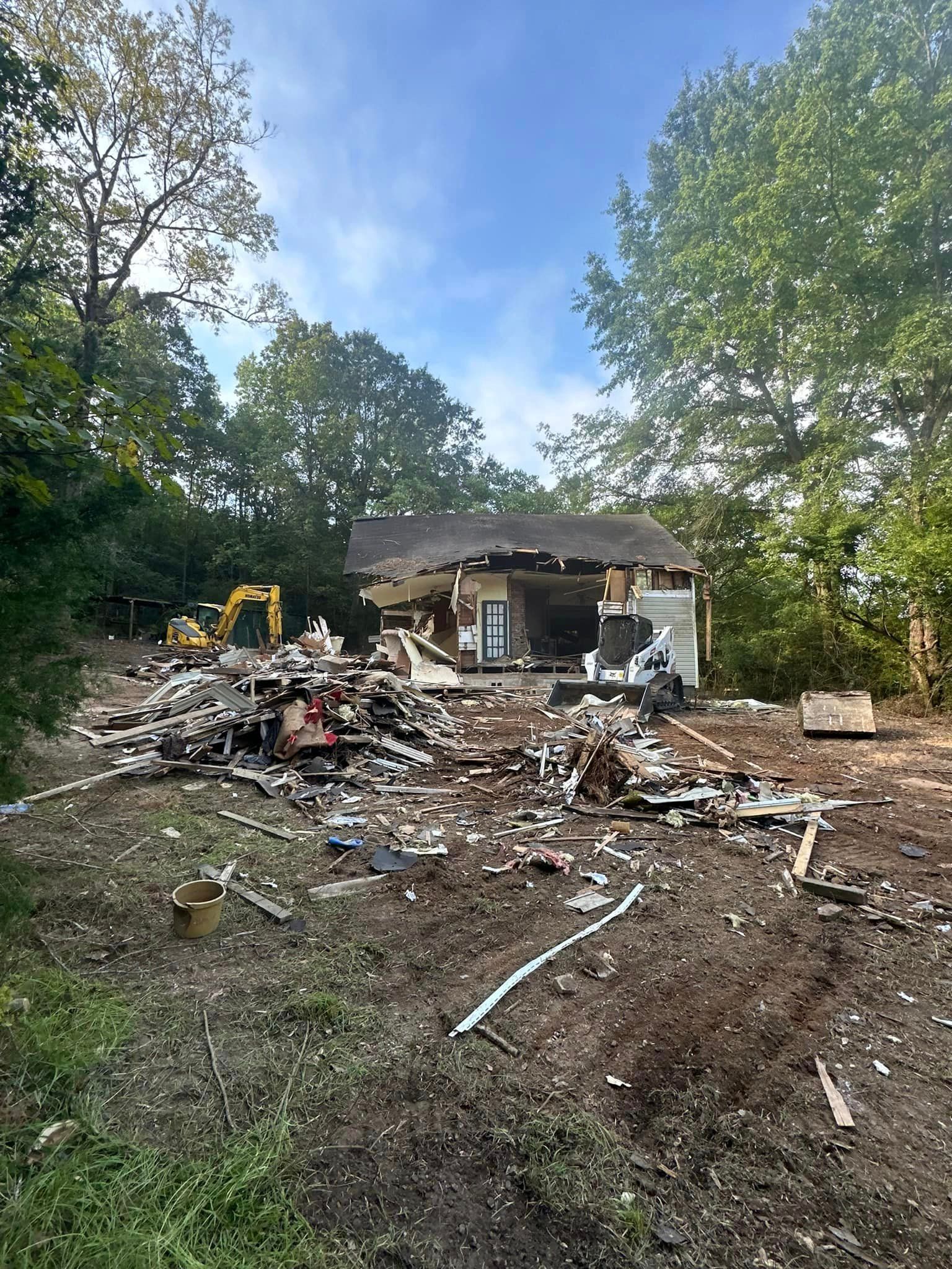 A house is being demolished in the middle of a forest.
