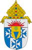 Heraldic shield with blue-and-white quartering, red rays, and a gold bishop’s mitre atop