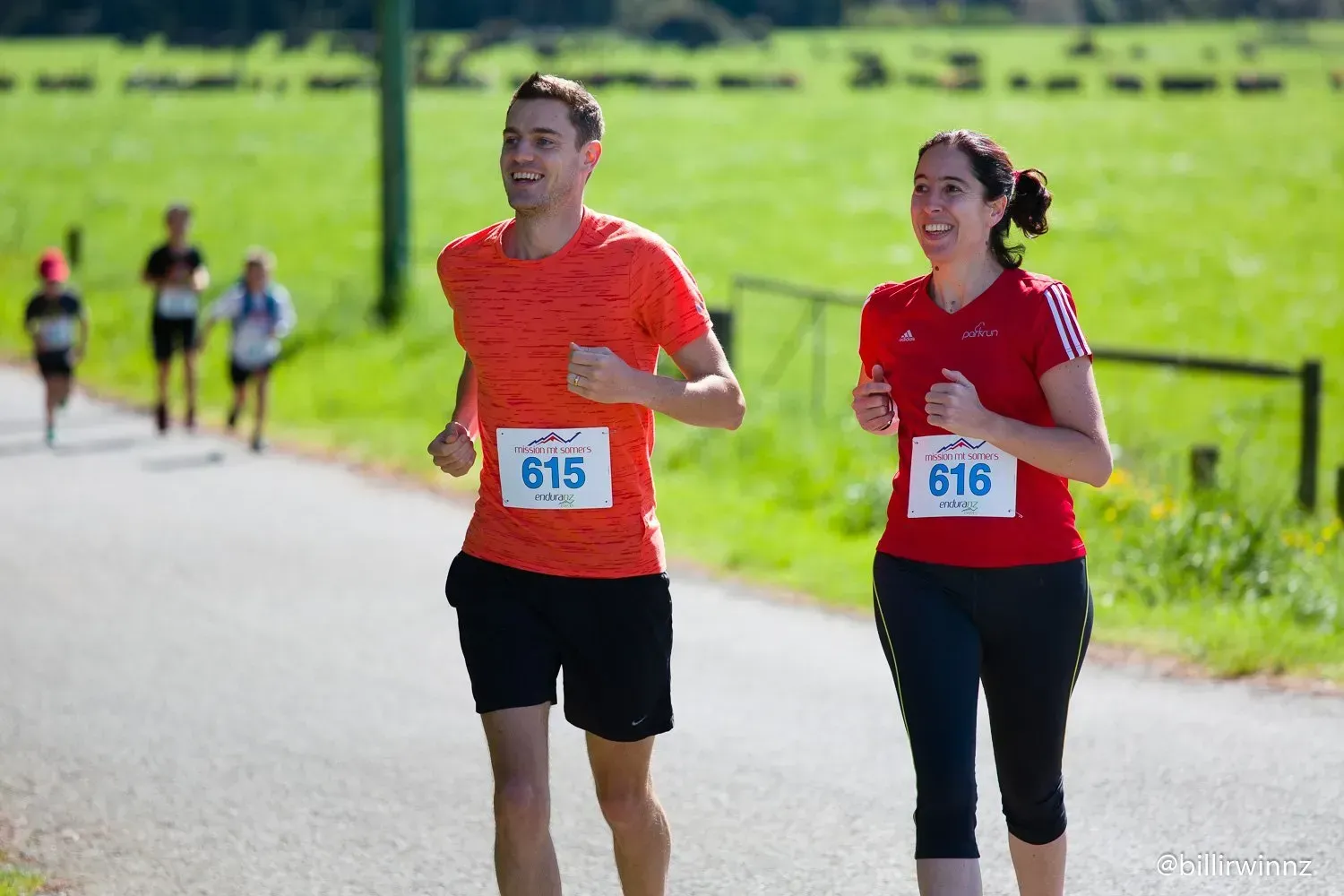 A man and a woman are running in a race.