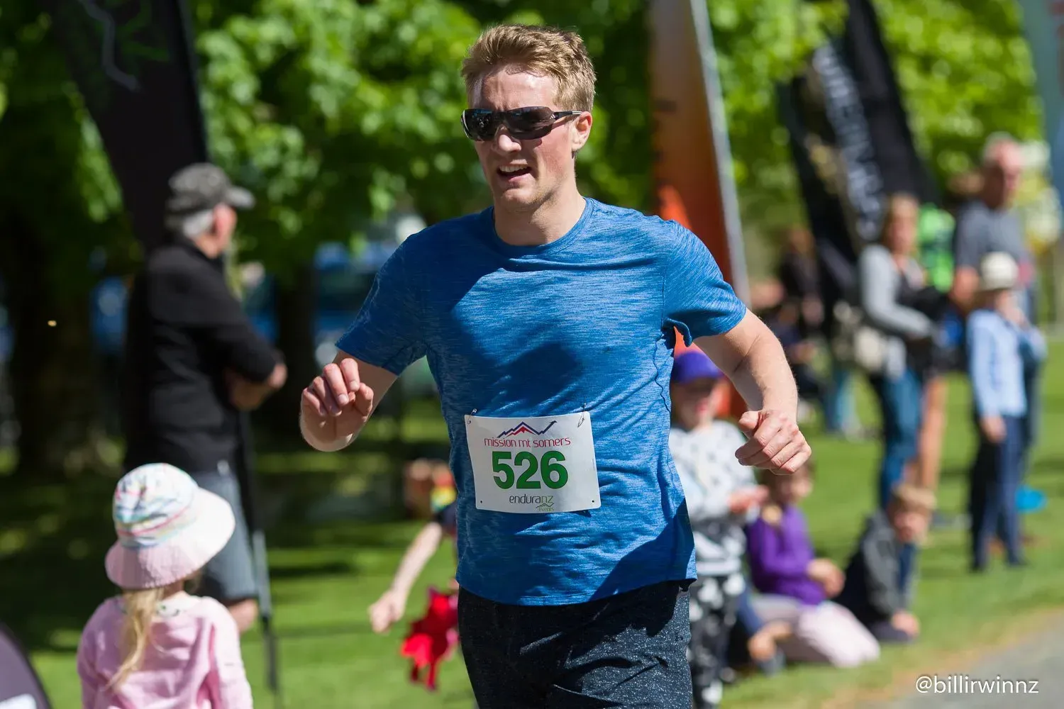 A man is running in a race with a number on his shirt.