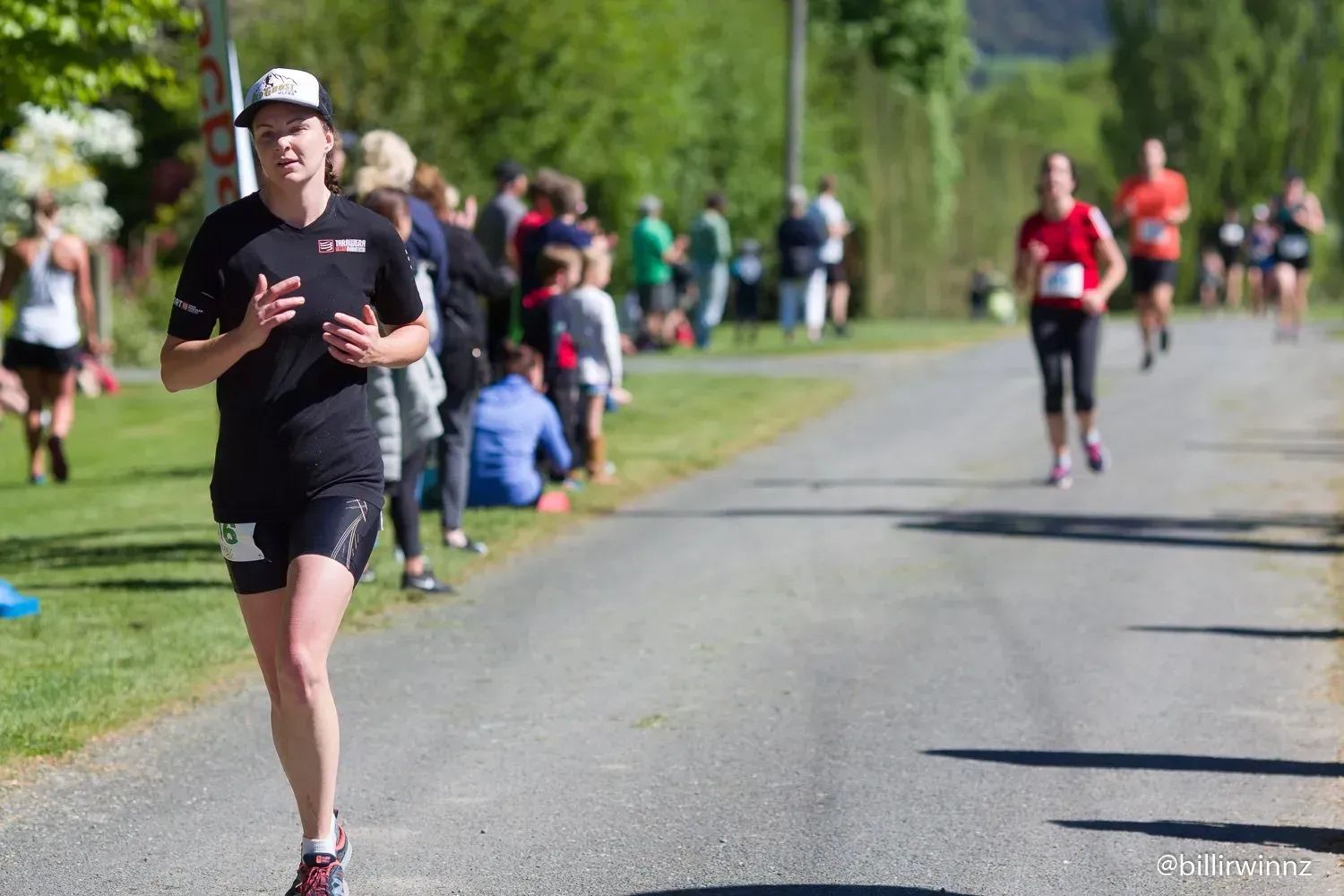 A group of people are running down a road.