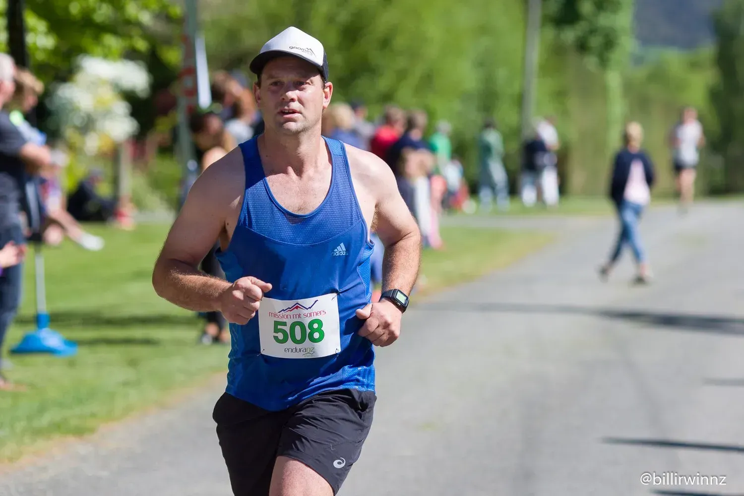 A man is running a marathon on a road.