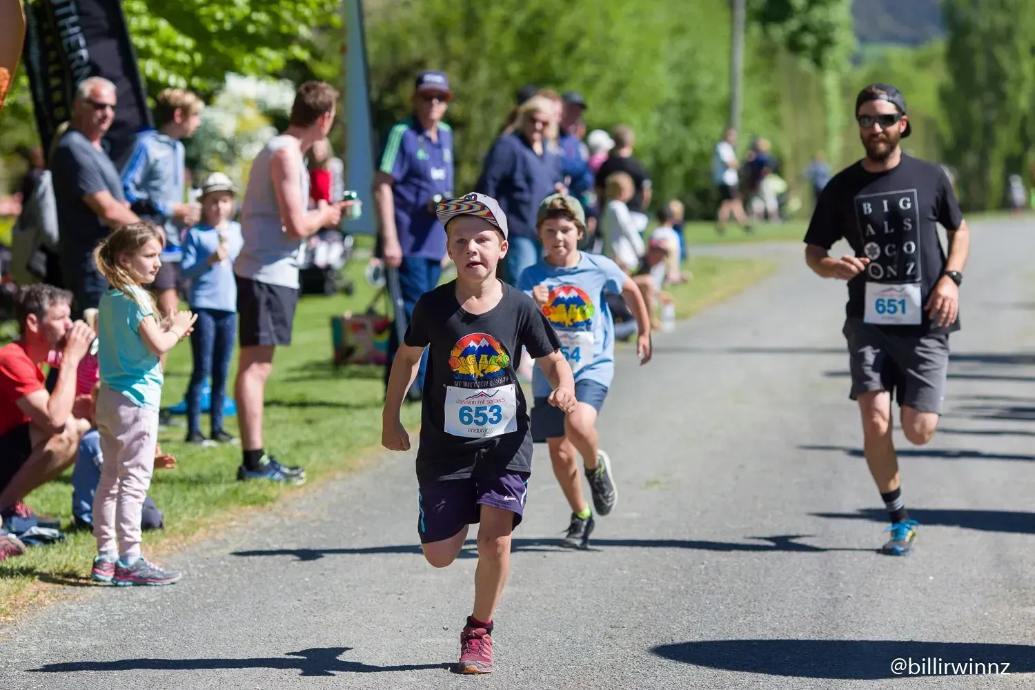 A group of people are running a race on a road.