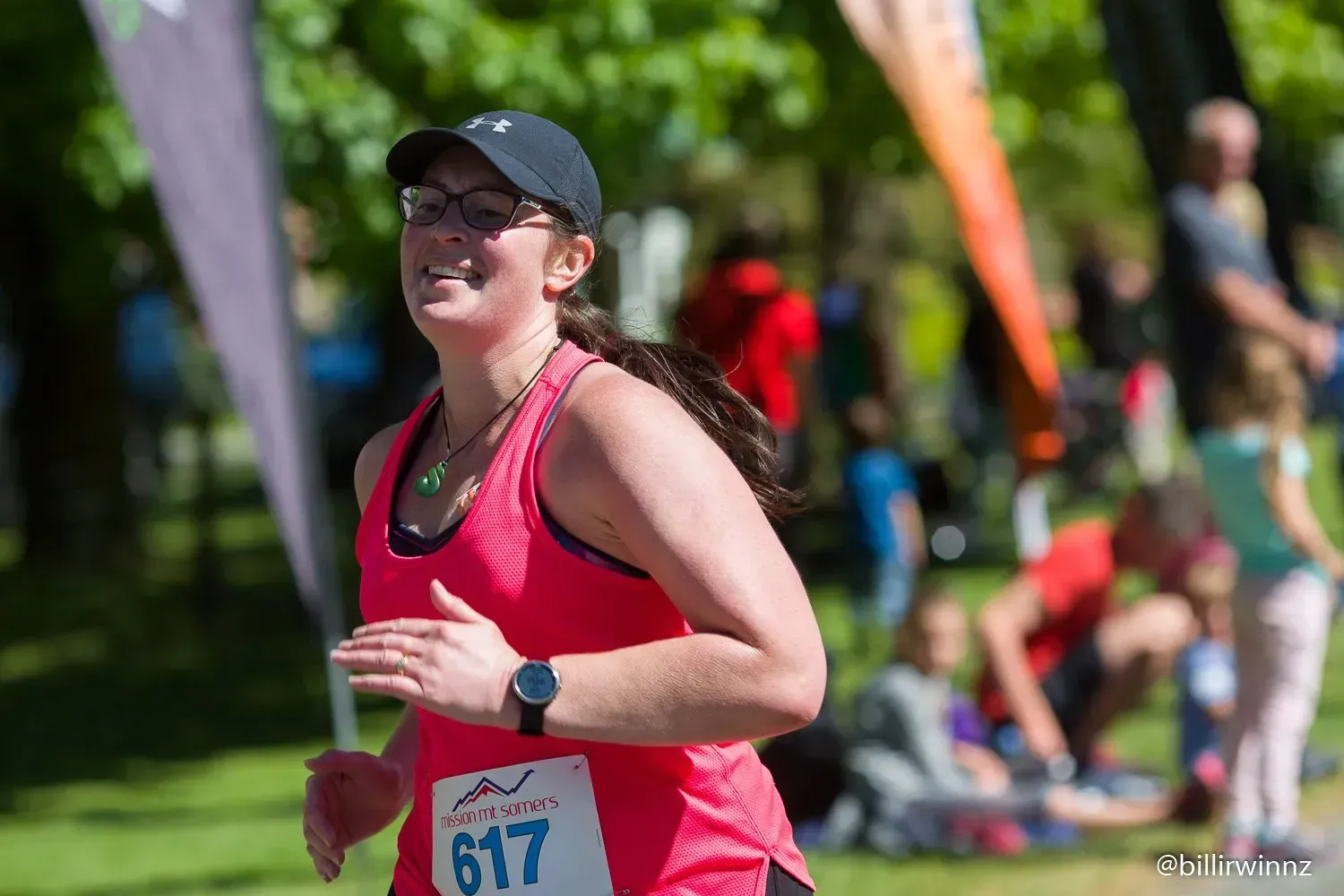 A woman is running in a race with a number on her shirt.