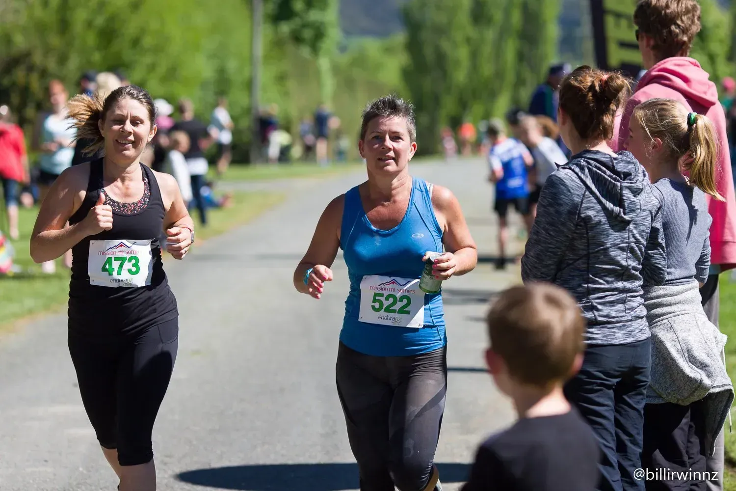 A group of women are running a race on a road.