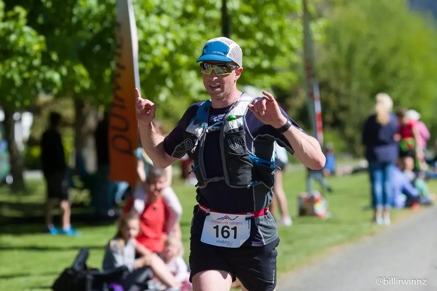 A man is running a race in a park.