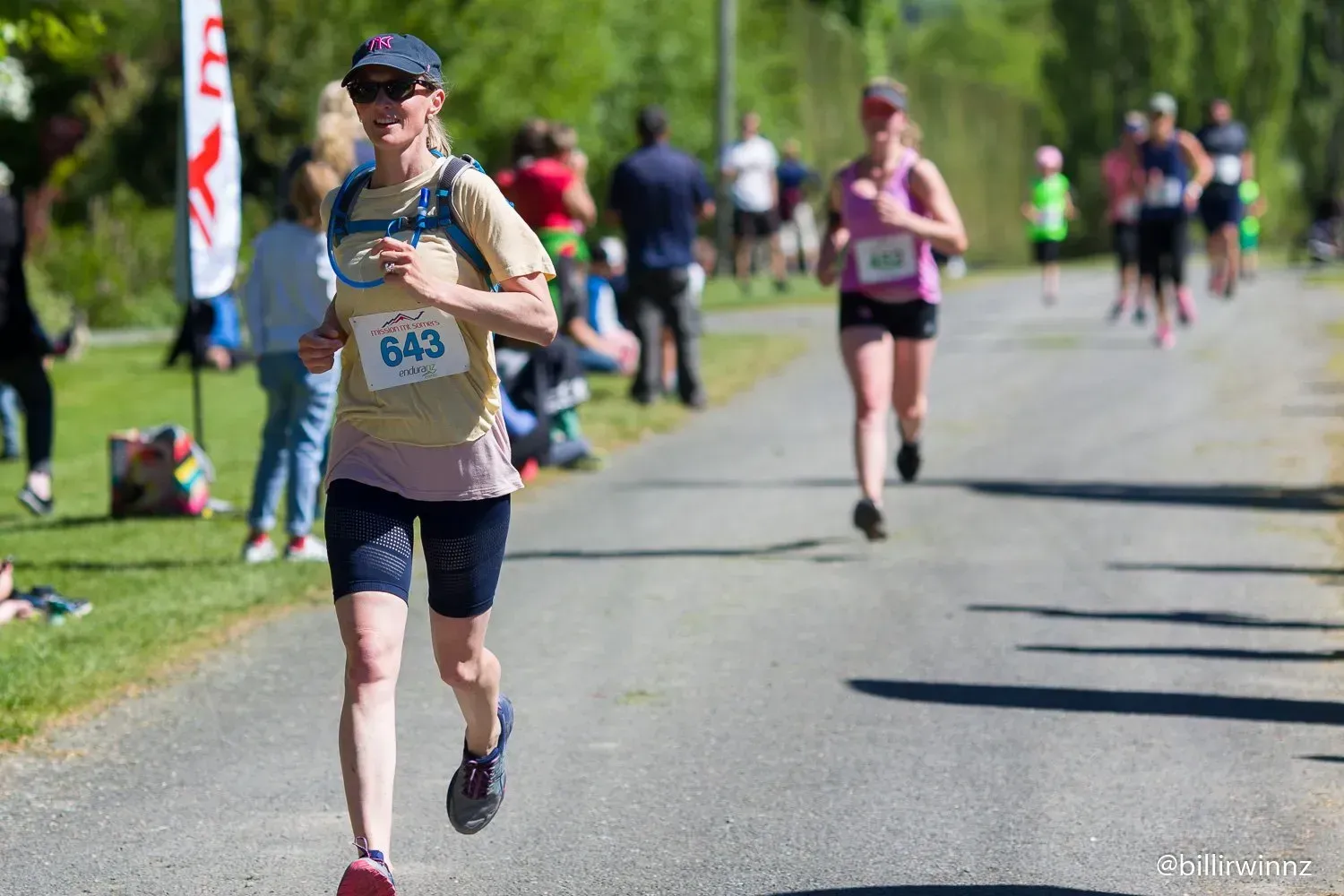 A woman is running a marathon on a path.
