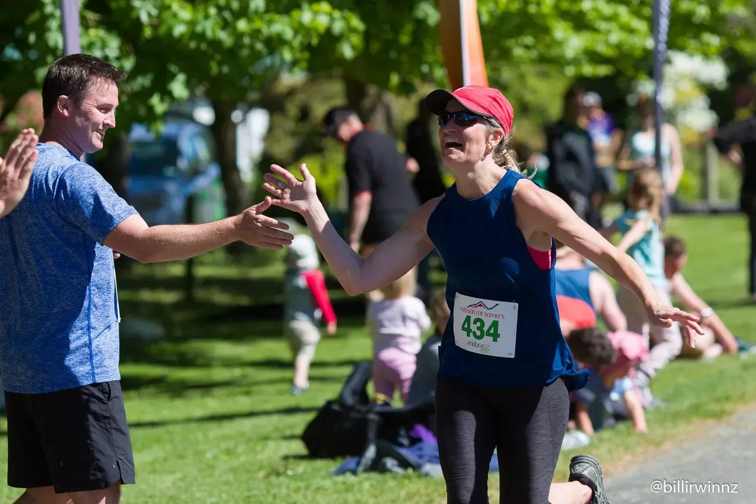 A man is giving a woman a high five after finishing a race.