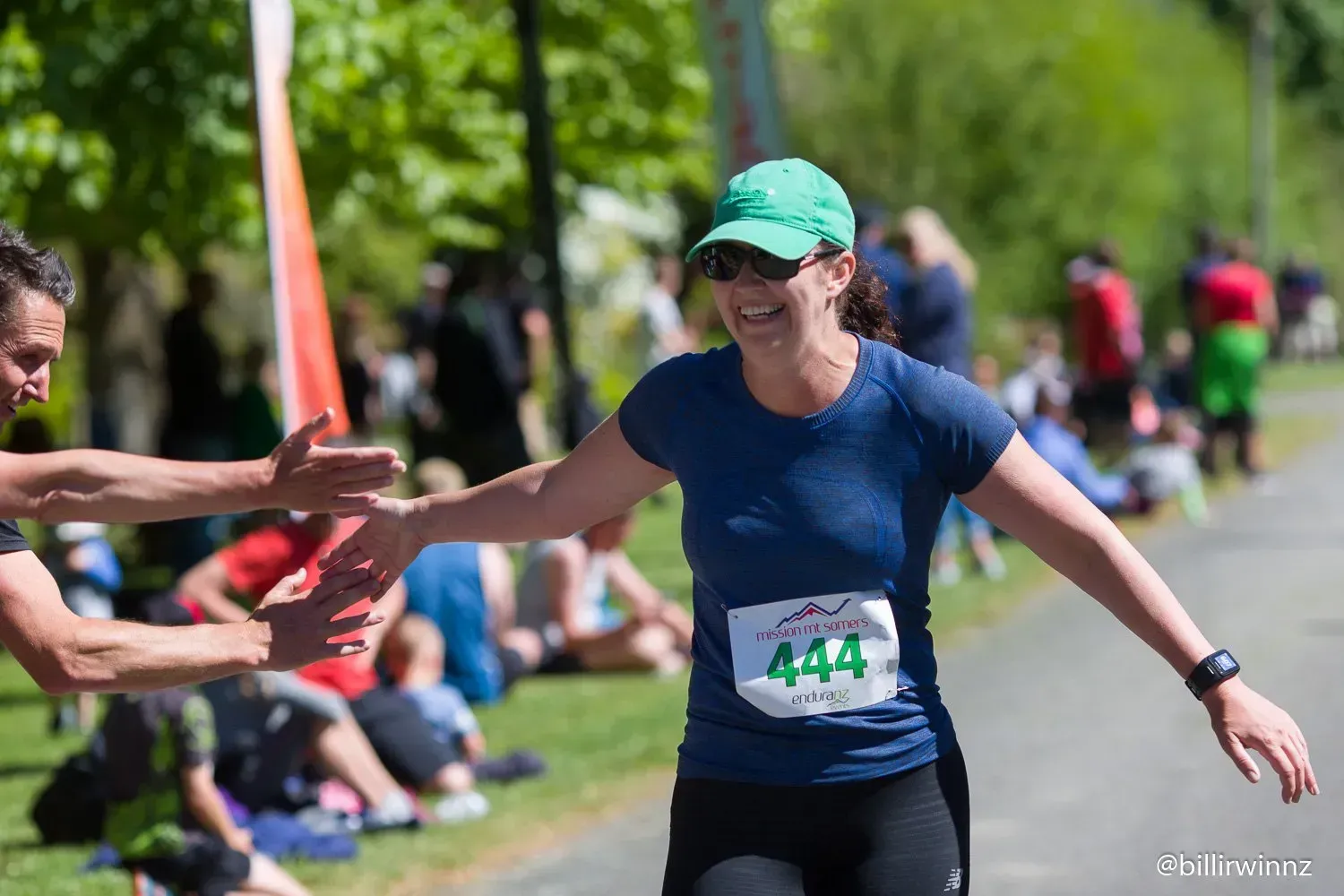 A man is giving a woman a high five in a race.