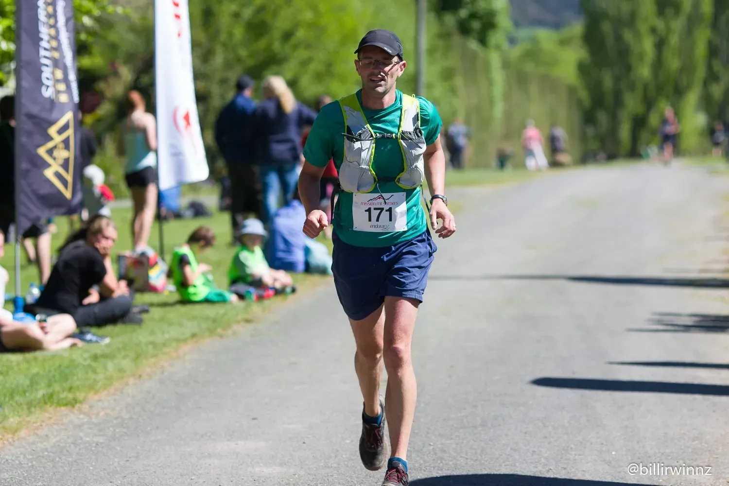 A man is running down a road in a race.