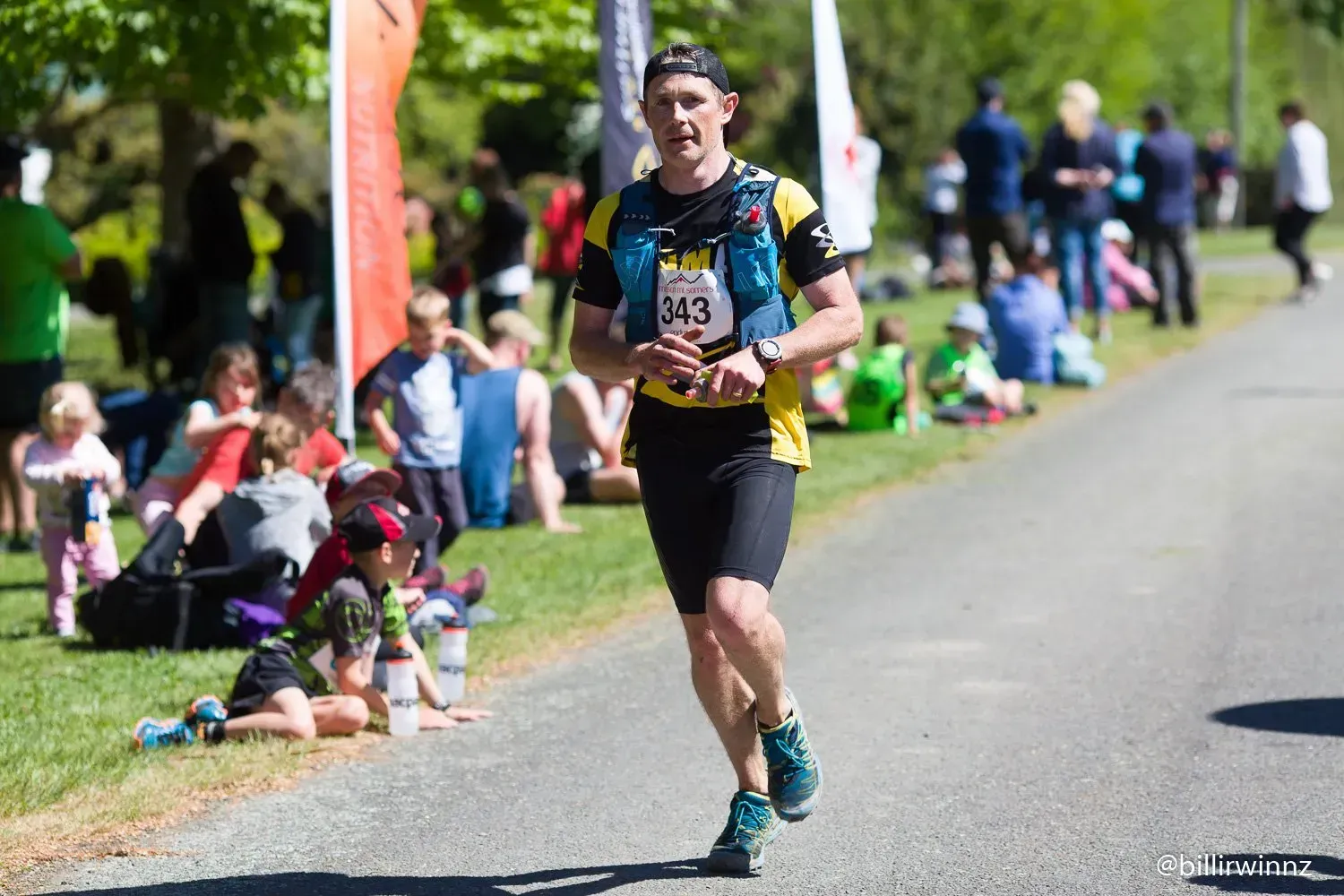 A man is running a marathon in a park.