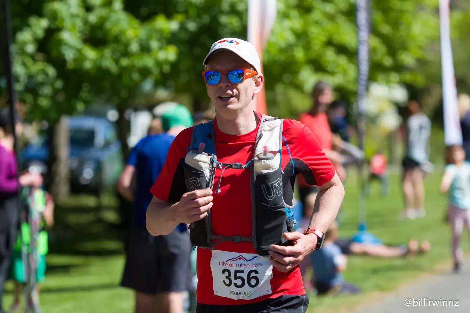 A man is running in a race with a number on his shirt.