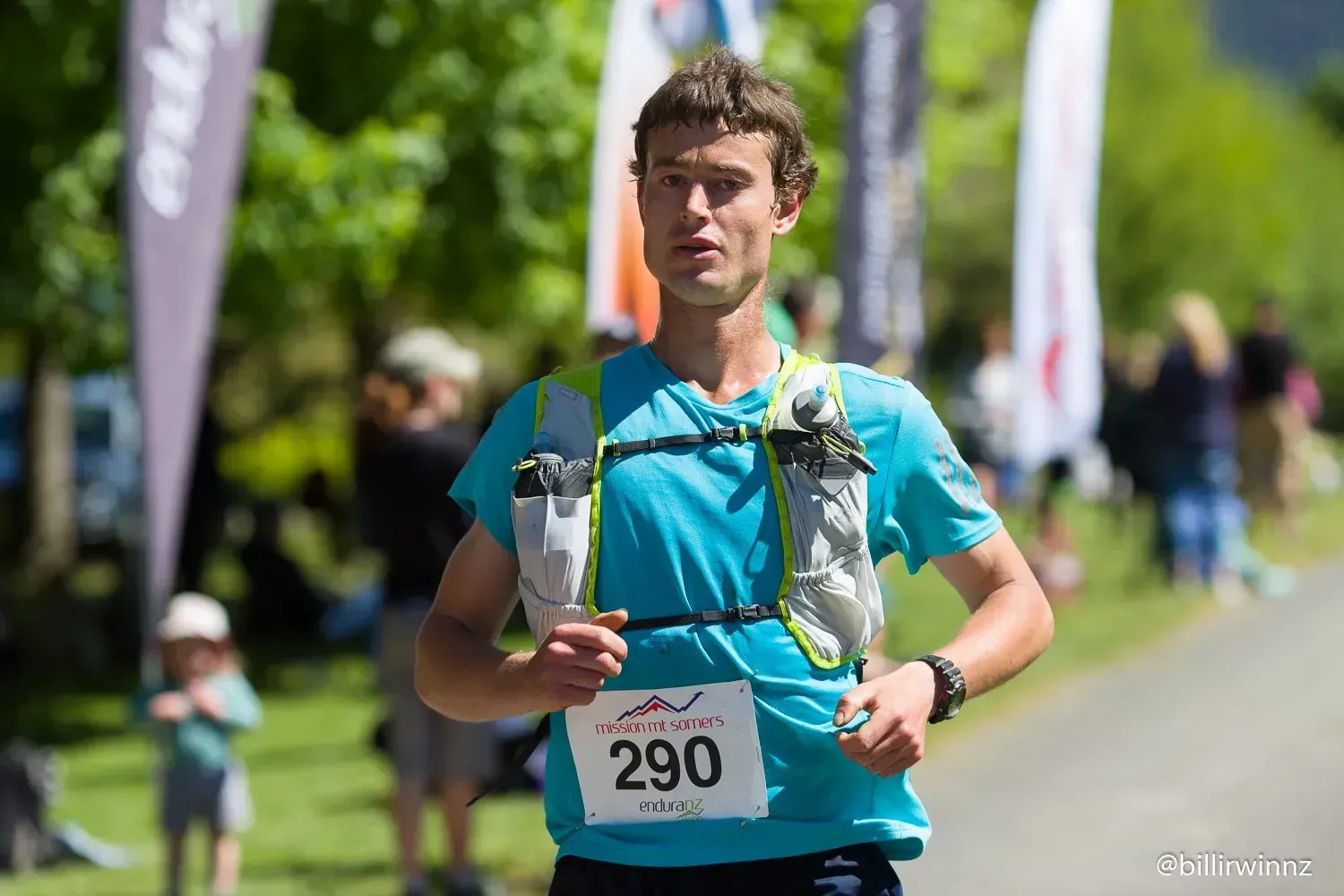 A man is running in a race with a number 290 on his shirt.