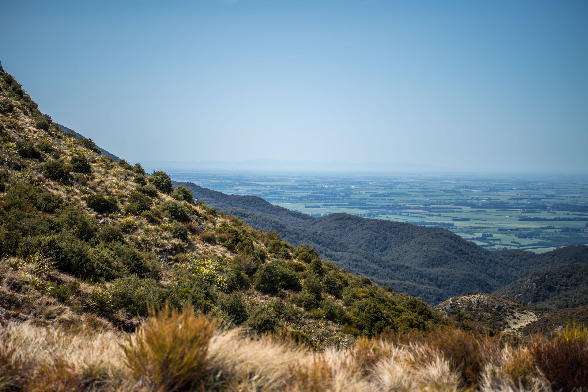 A view of a valley from the top of a mountain.