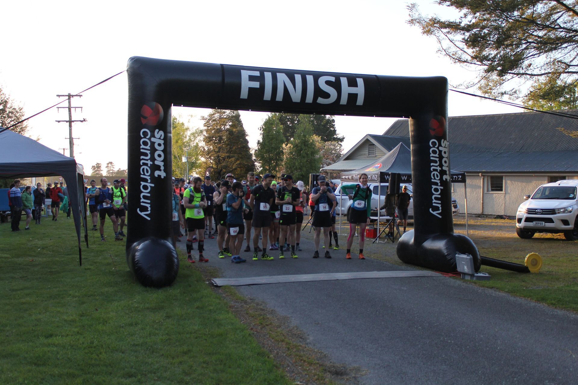 A group of people are gathered at the finish line of a race