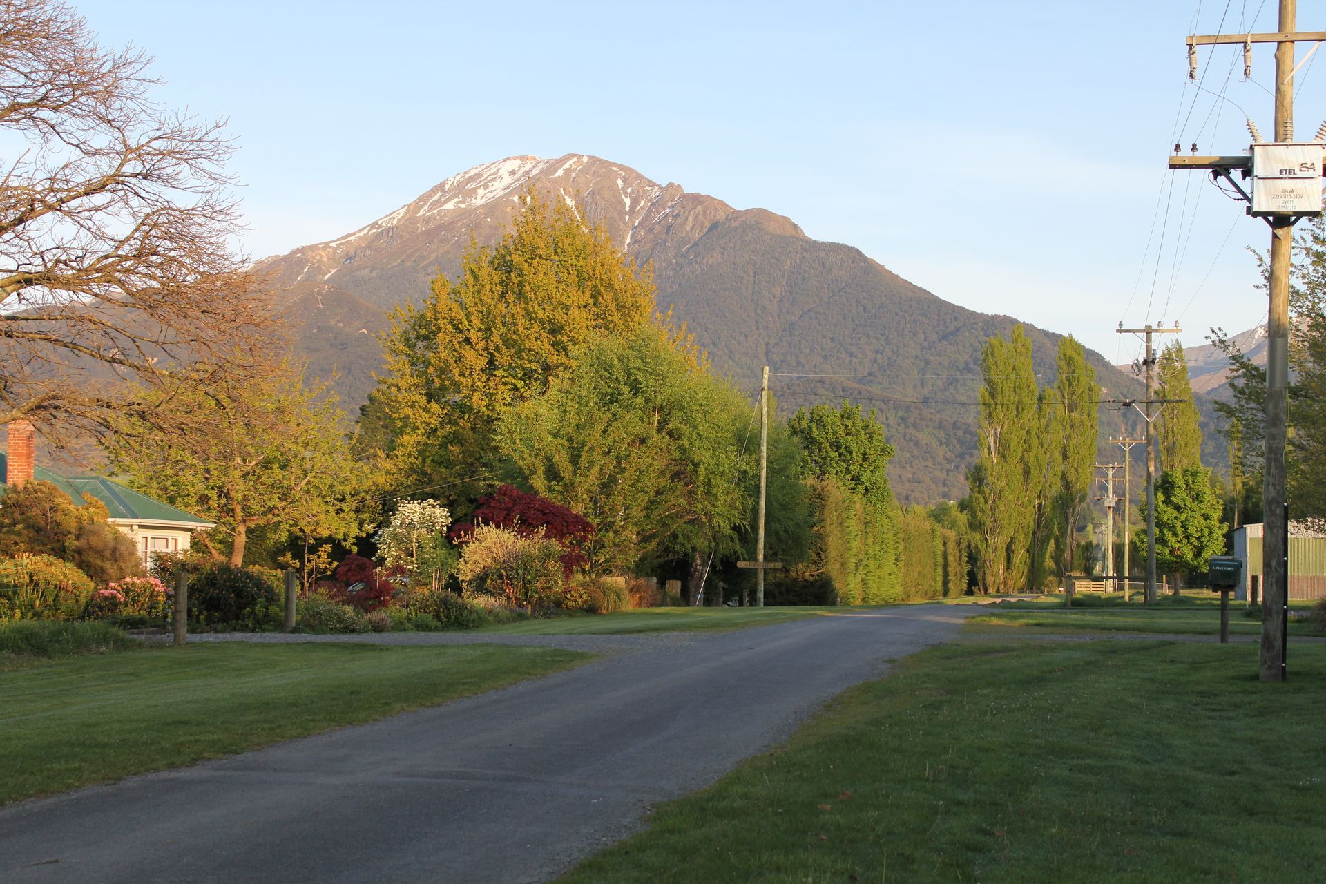 A residential street with a mountain in the background