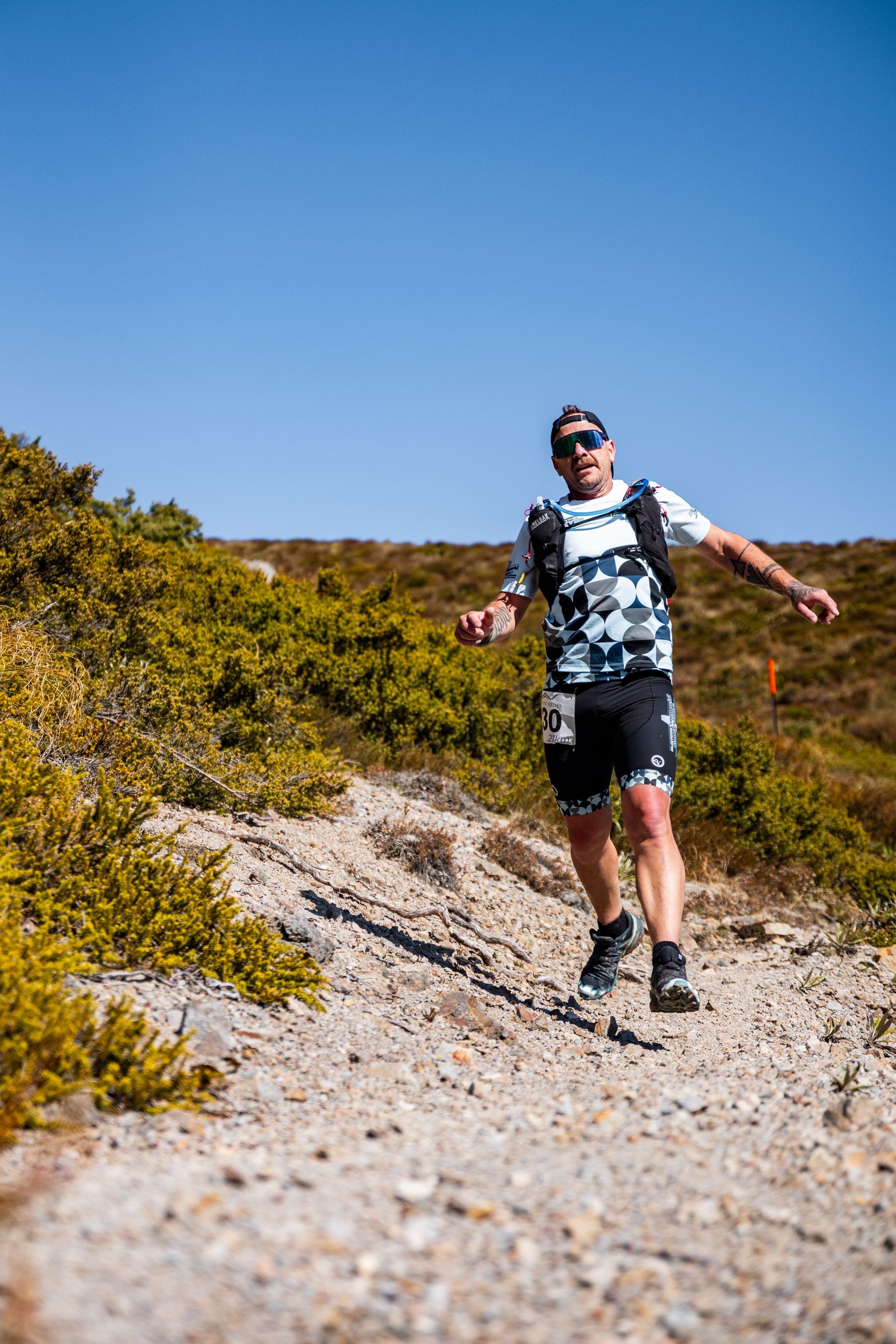 A man is running up a dirt hill.