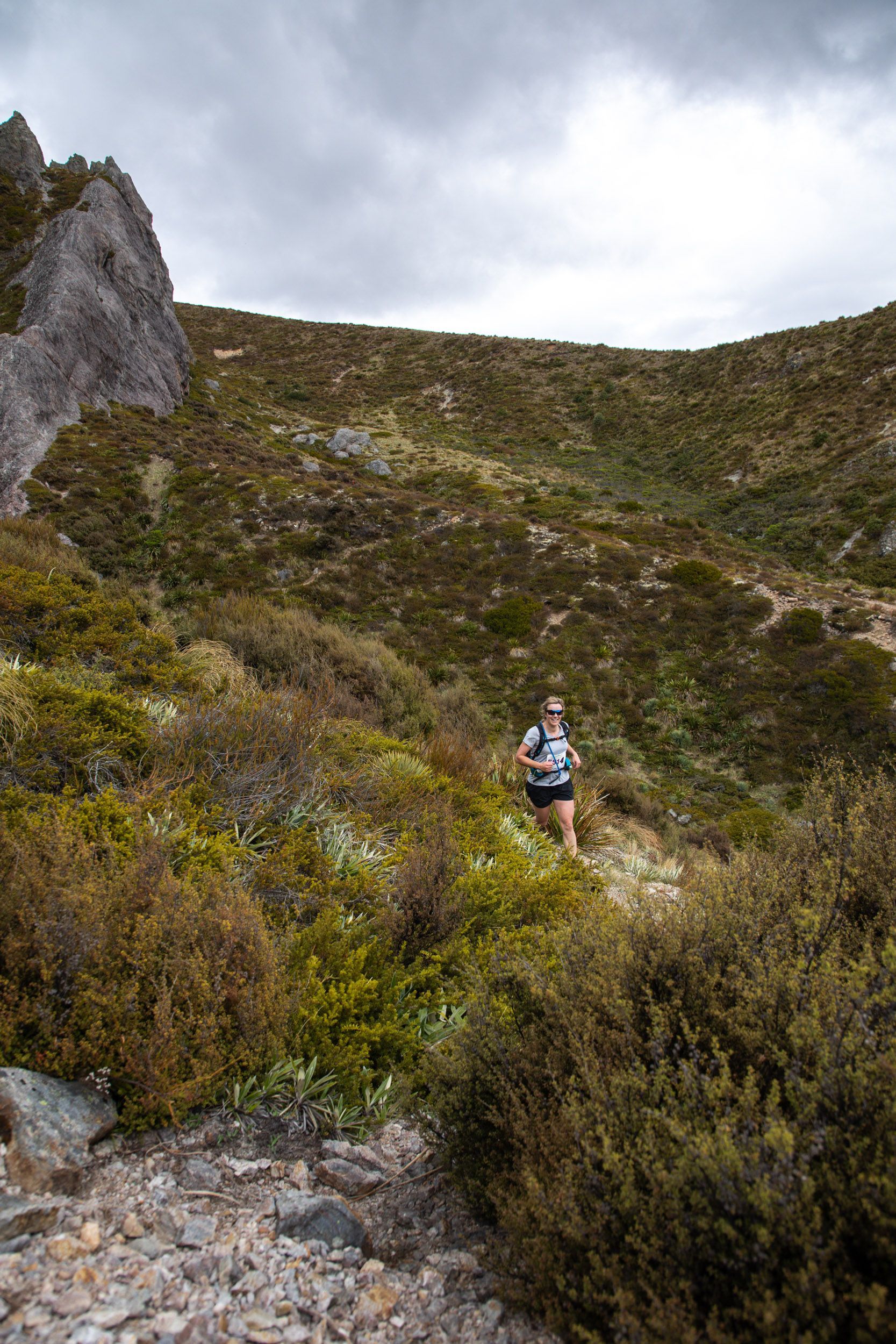 A person is running on a trail in the mountains.