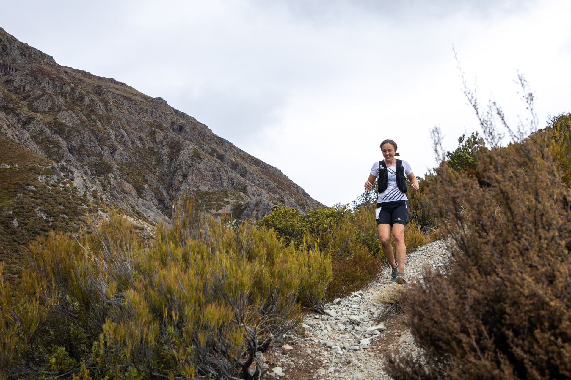 A person is running on a trail in the mountains.