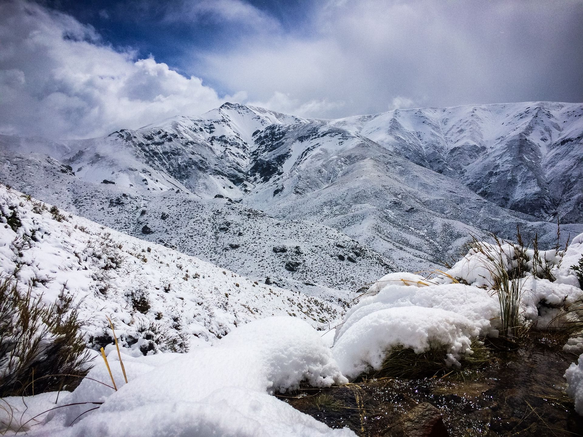 There is a lot of snow on the ground in the mountains.