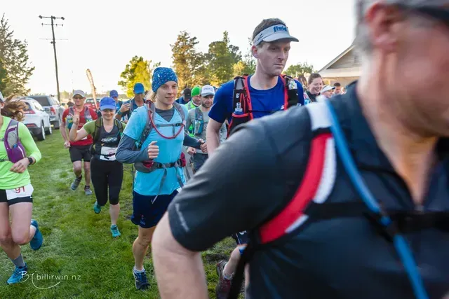 A group of people are running in a field.