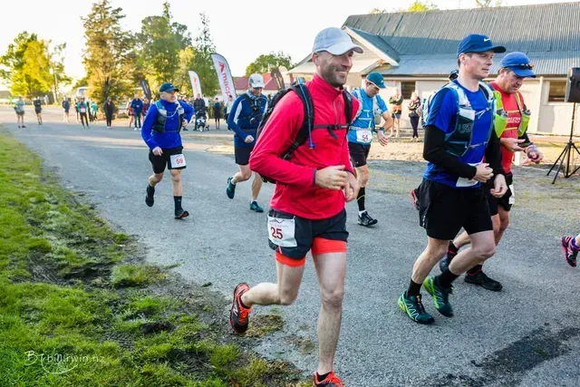 A group of men are running down a road.