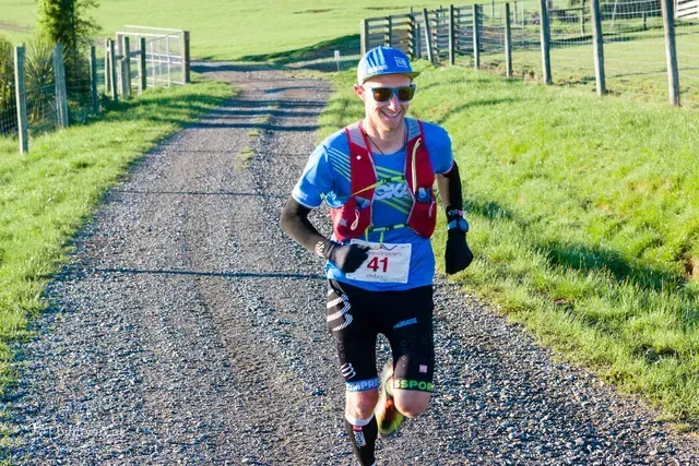 A man is running down a dirt road.
