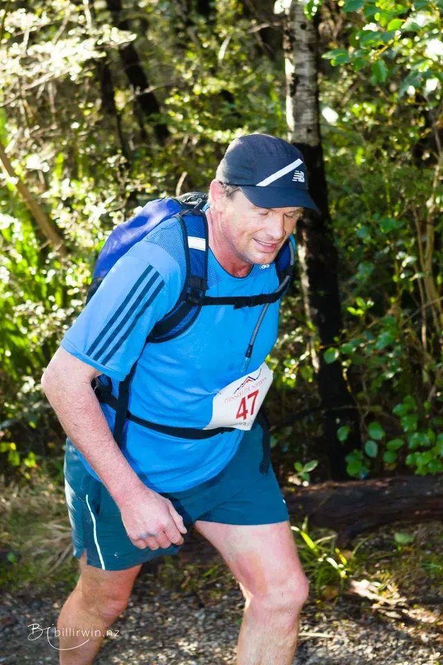 A man wearing a blue shirt with the number 47 on it