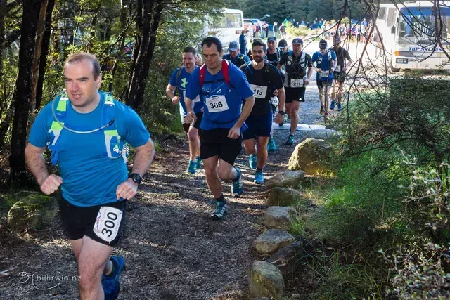 A group of men are running a race and one of them has the number 300 on his shorts