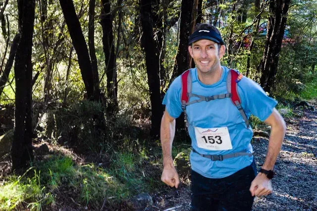 A man wearing a blue shirt with the number 153 on it