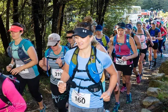 A group of women are running a trail race.