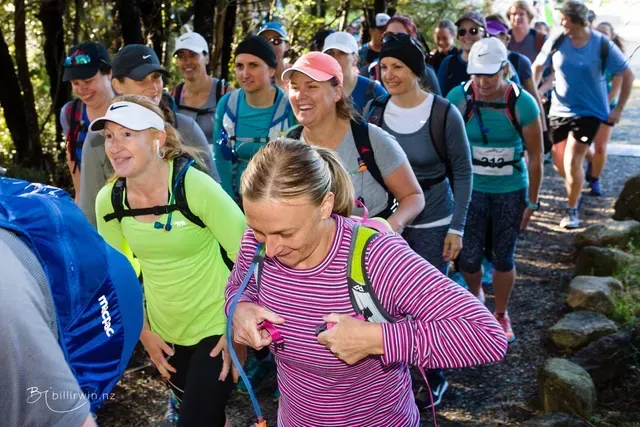 A group of people are walking down a path.