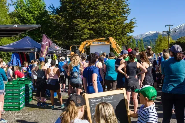 A large group of people are standing in a parking lot.