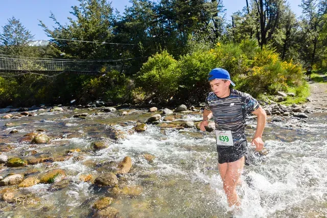 A man is running through a stream of water.