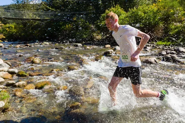 A man is running through a stream of water.