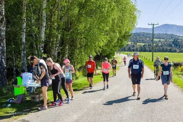 A group of people are walking down a road.
