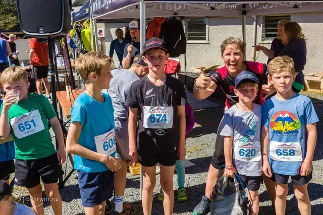 A group of young boys are posing for a picture at a race.
