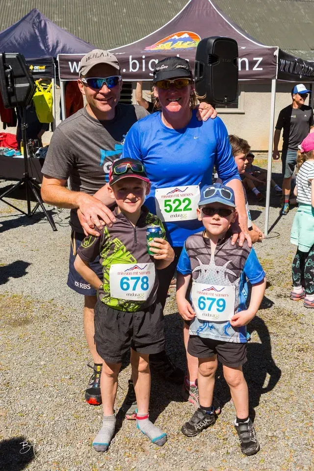 A group of people are posing for a picture in front of a tent.