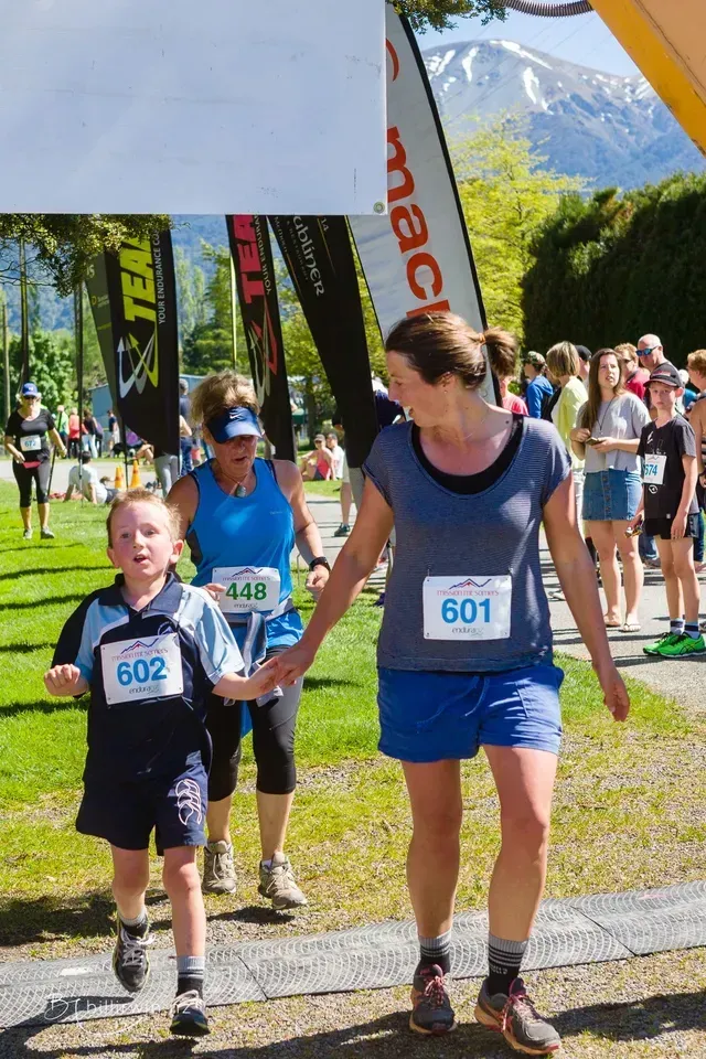 A woman and a child are running in a race.