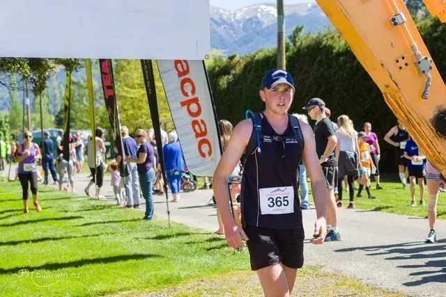 A man with the number 365 on his shirt is running in a race.