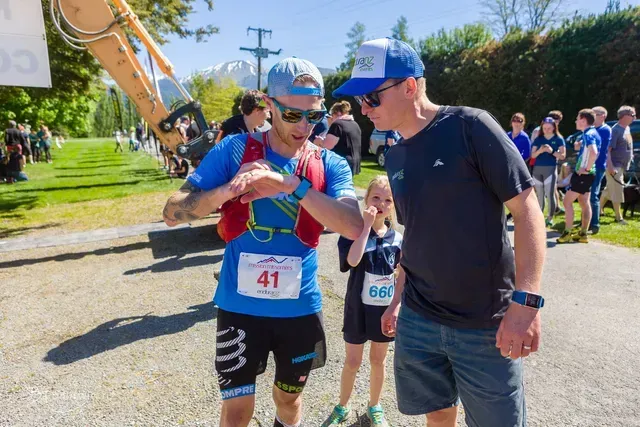 A man in a blue shirt with the number 41 on it is talking to another man.